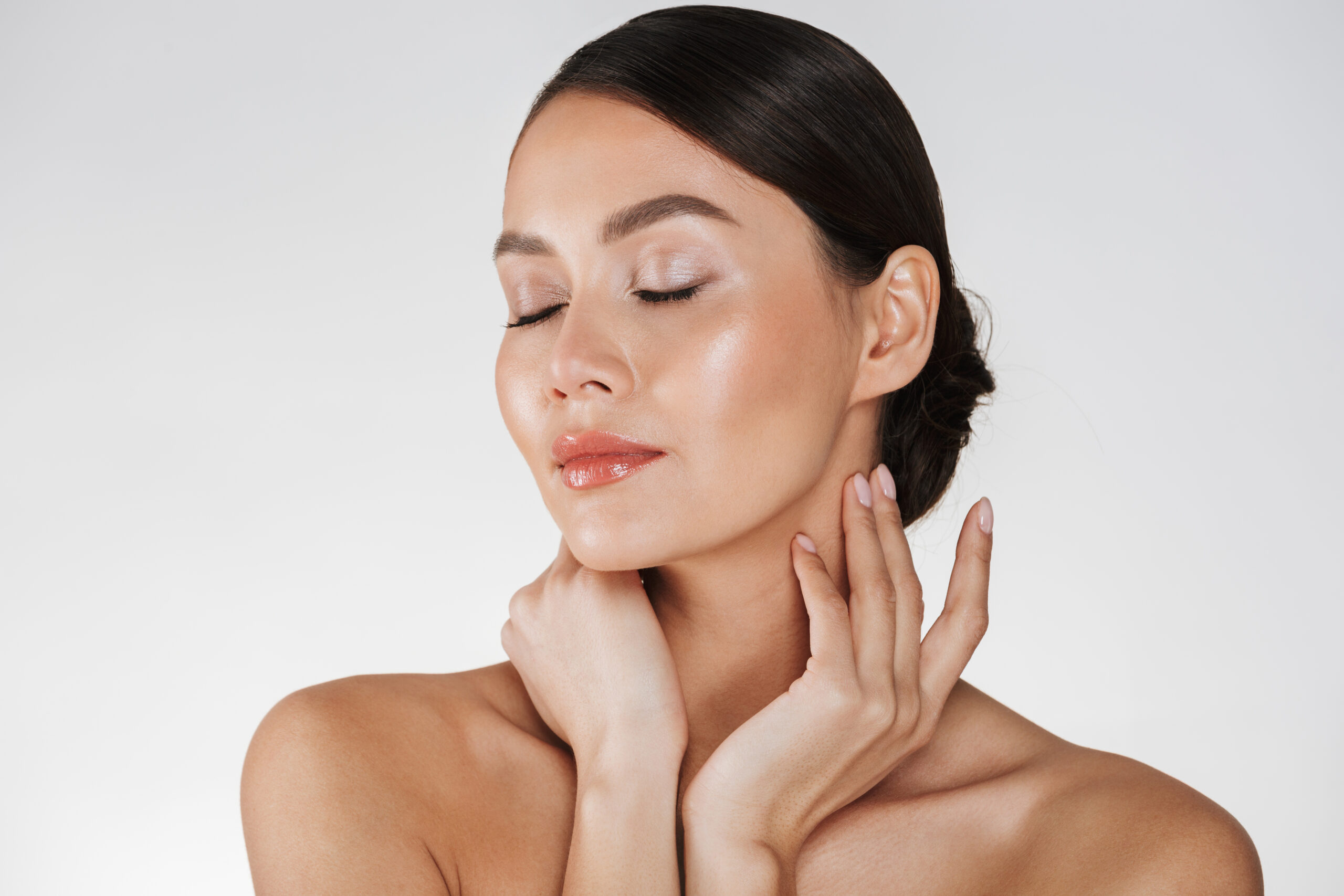 close up relaxed brunette woman with soft skin posing camera with closed eyes isolated white scaled
