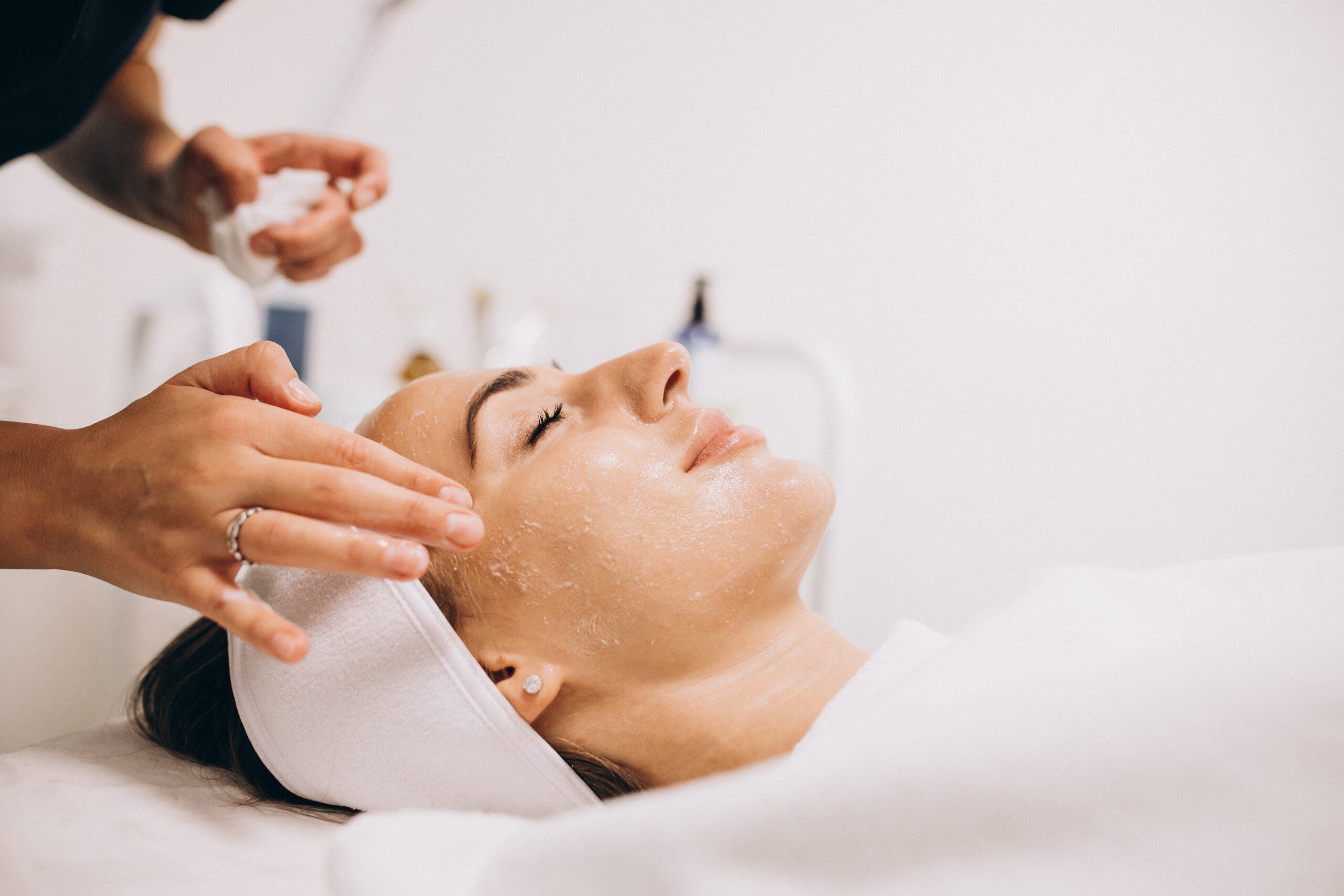 cosmetologist cleaning face woman beauty salon 1 scaled